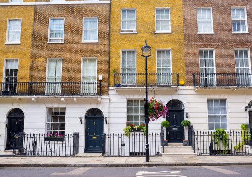 Facade of Georgian residential town houses made in yellow and red brick in a luxury residential area of West London.